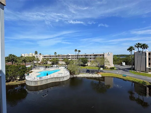 a view of a swimming pool with an outdoor seating space