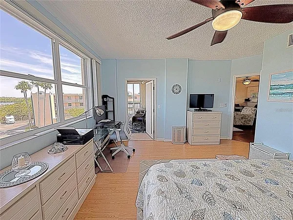 a bed room with a bed and a television