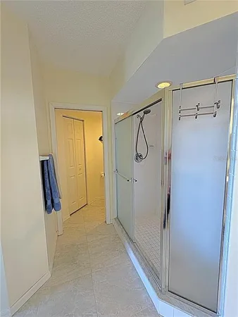 a bathroom with a glass shower door and a sink