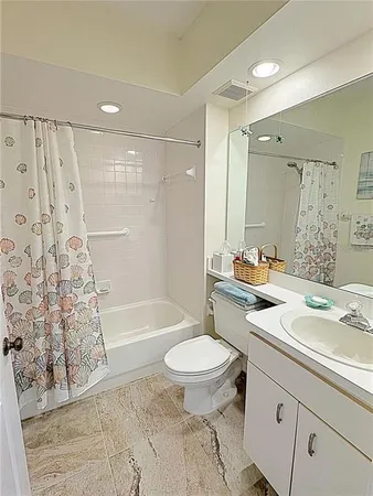a bathroom with a sink toilet a mirror and shower