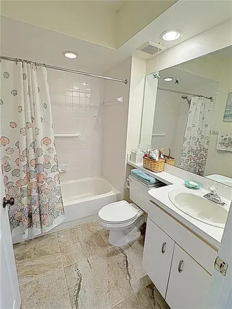 a bathroom with a sink toilet a mirror and shower