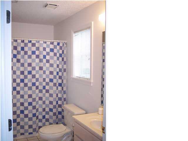11 Beachside Drive, Unit 1211 Santa Rosa Beach, FL 32459 - Photo 13 of 15 a bathroom with a toilet and a shower curtain