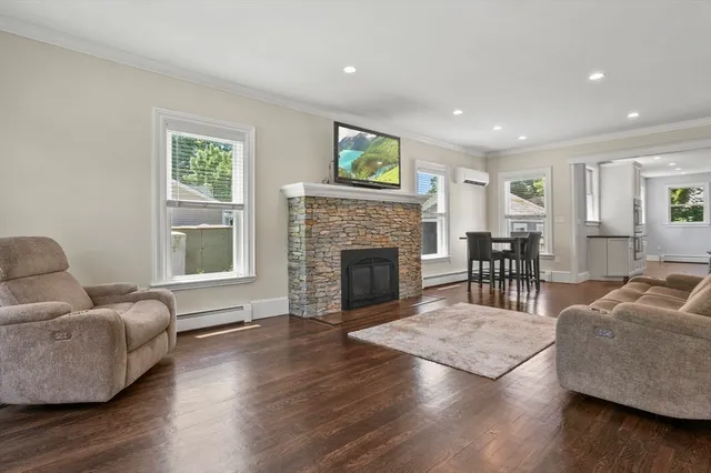 a living room with furniture and a fireplace