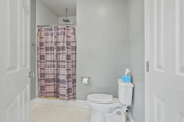 a bathroom with a toilet and shower