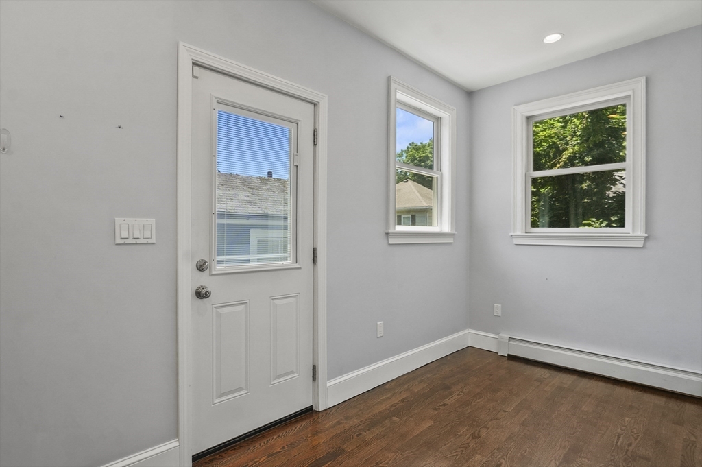 5 Waban Street Natick, MA 01760 - Photo 17 of 32 a view of an empty room with wooden floor and a window