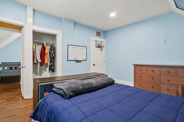 a bedroom with a bed and a dresser