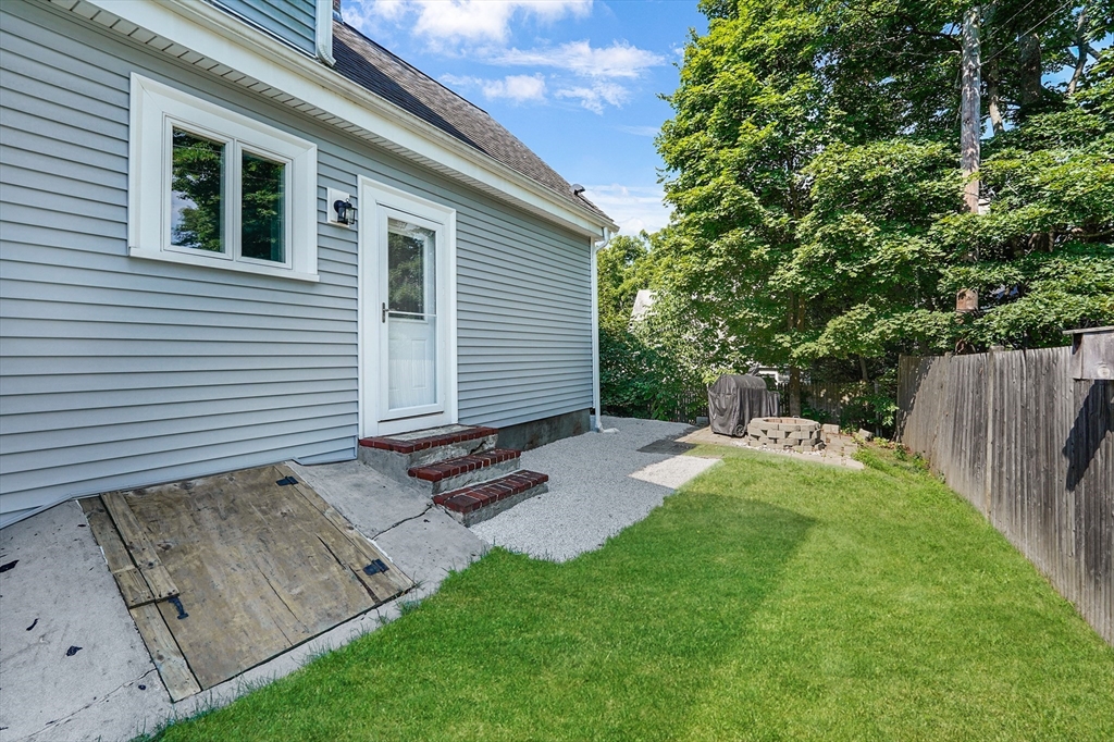 5 Waban Street Natick, MA 01760 - Photo 29 of 32 a view of backyard with table and chairs and wooden fence