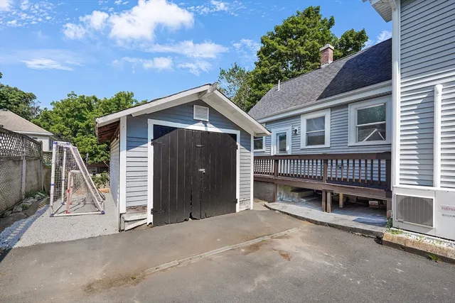 a view of a house with a yard and wooden fence