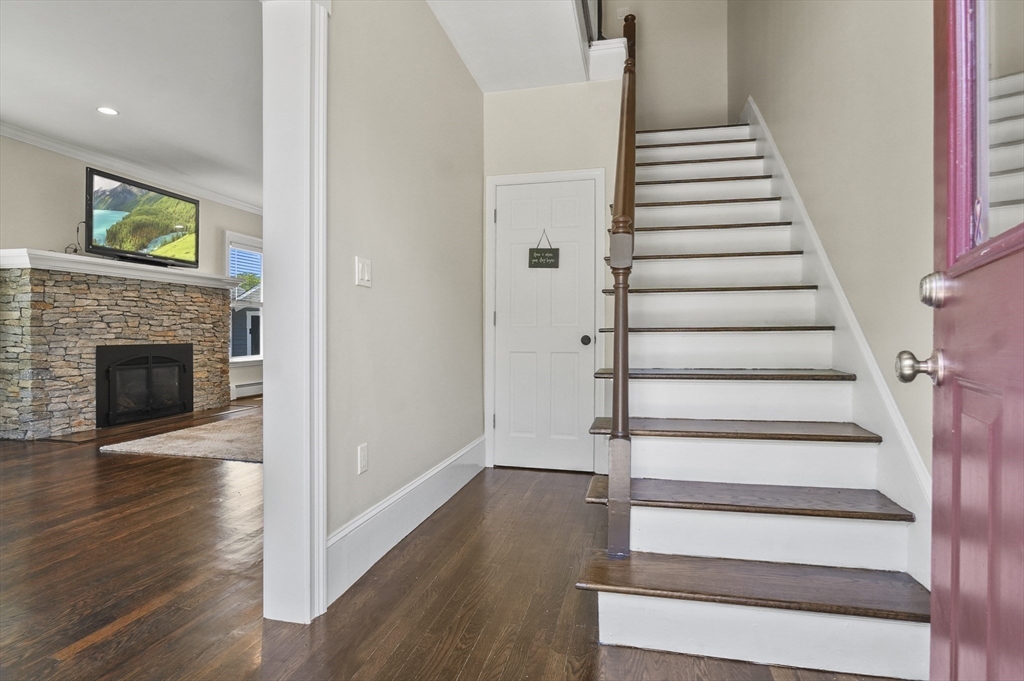 5 Waban Street Natick, MA 01760 - Photo 4 of 32 a view of an entryway with wooden floor and a fireplace