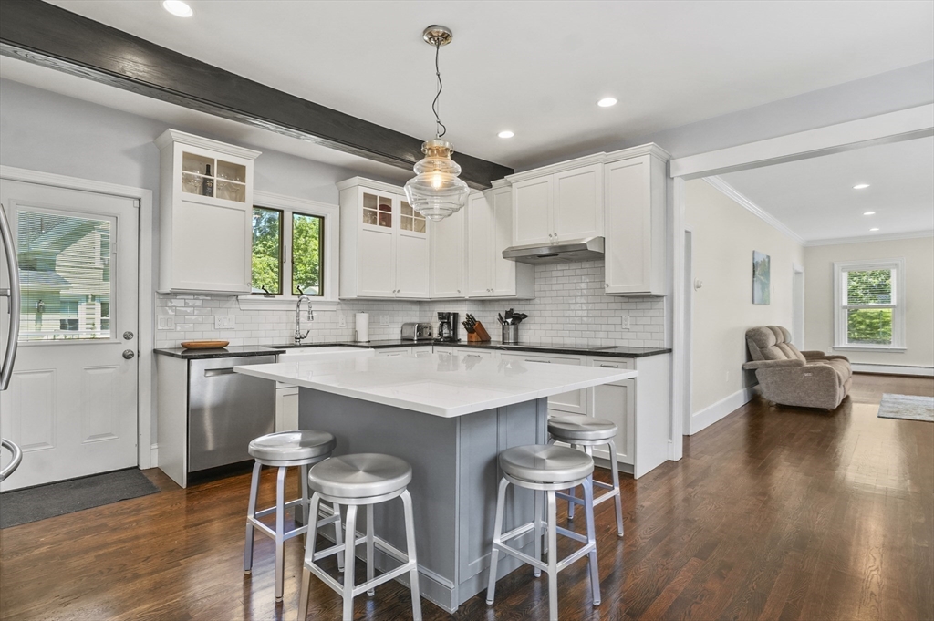 5 Waban Street Natick, MA 01760 - Photo 5 of 32 a kitchen with stainless steel appliances granite countertop a table chairs refrigerator and sink
