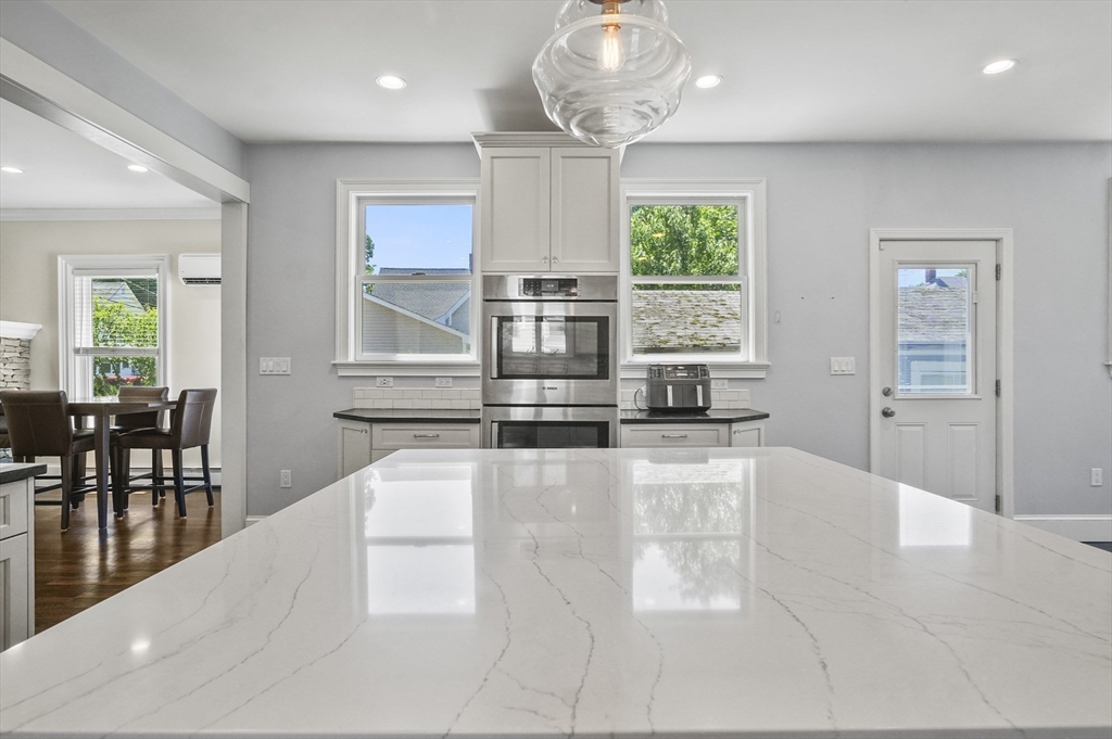5 Waban Street Natick, MA 01760 - Photo 8 of 32 an open kitchen with granite countertop a stove and white cabinets