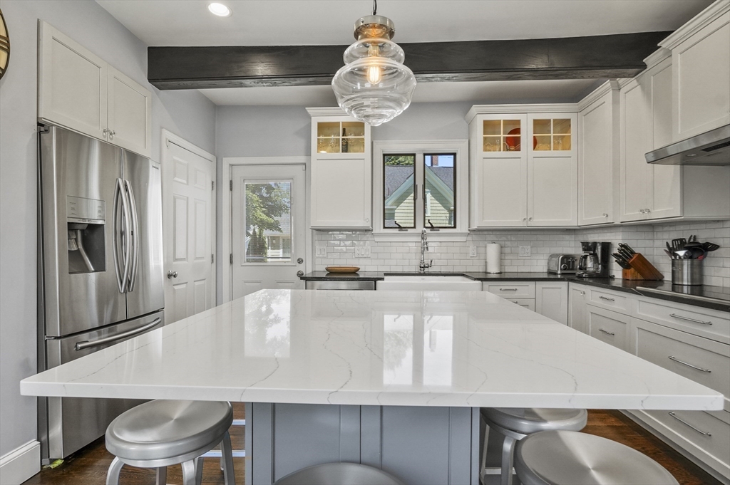 5 Waban Street Natick, MA 01760 - Photo 9 of 32 a kitchen with stainless steel appliances granite countertop a kitchen island hardwood floor sink and stove