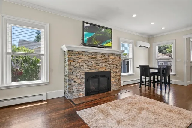 a living room with furniture a fireplace and a flat screen tv
