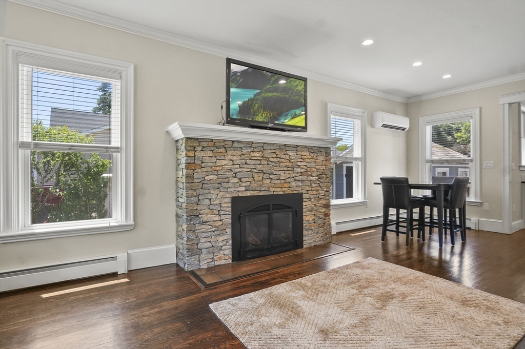 5 Waban Street Natick, MA 01760 - Photo 10 of 32 a living room with furniture a fireplace and a flat screen tv