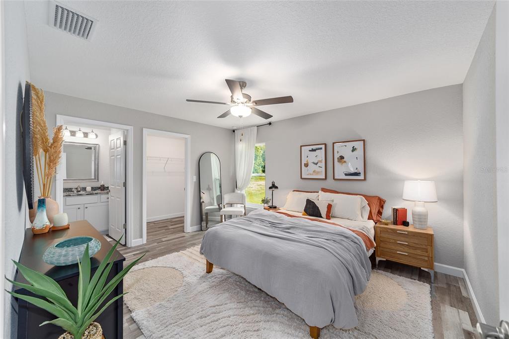 8571 Southwest 131st Place Ocala, FL 34473 - Photo 19 of 32 a bedroom with a bed and ceiling fan