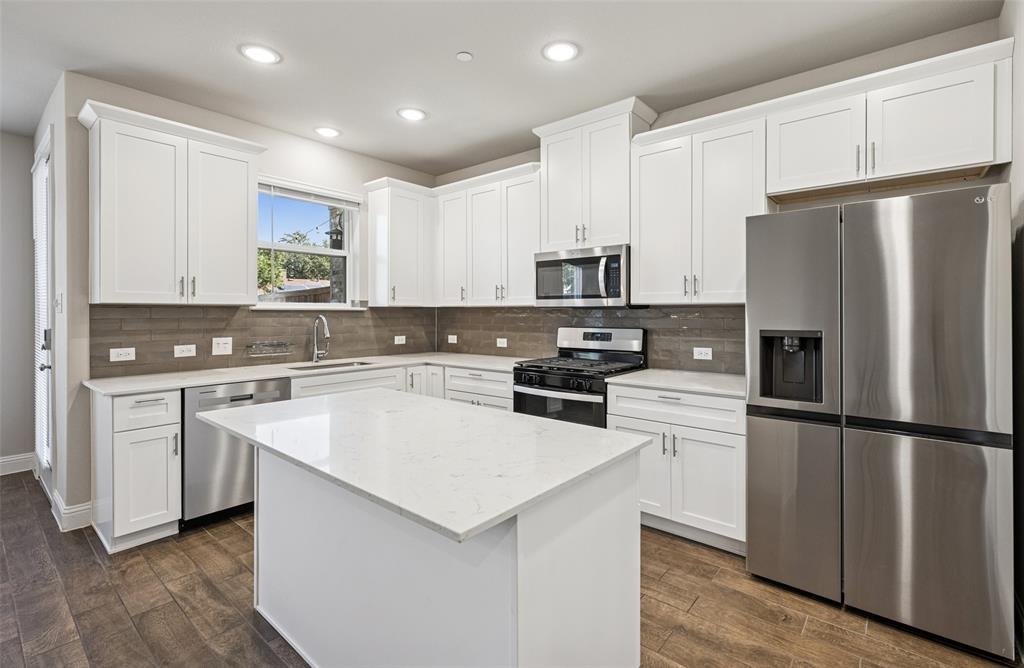 3073 Hamilton Street Plano, TX 75075 - Photo 13 of 30 a kitchen with white cabinets and stainless steel appliances