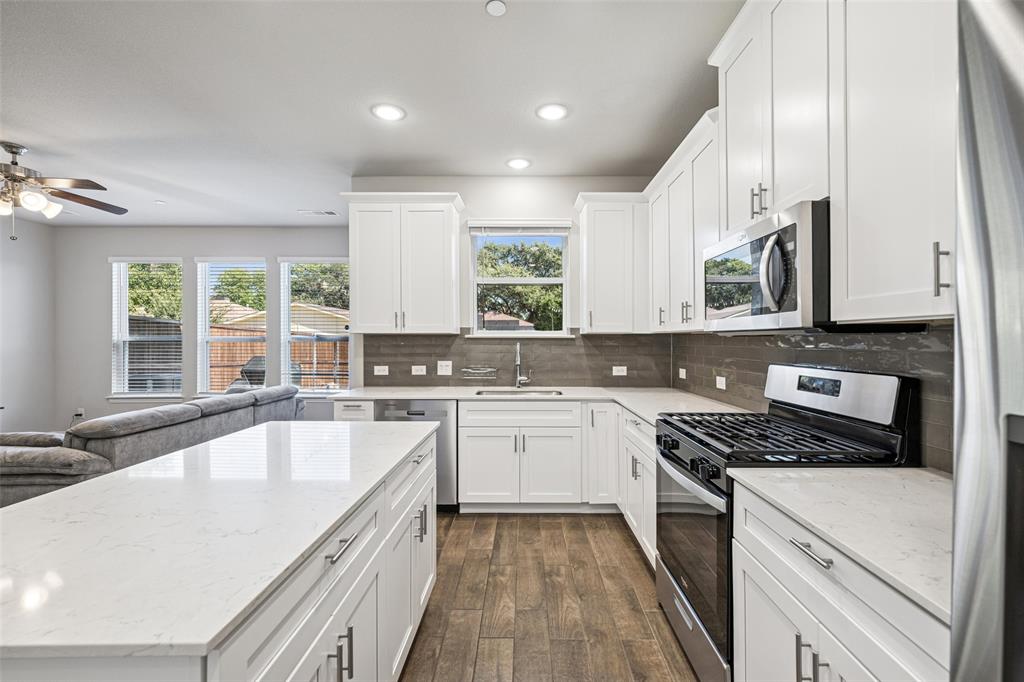 3073 Hamilton Street Plano, TX 75075 - Photo 15 of 30 a kitchen with a sink a window stainless steel appliances and cabinets