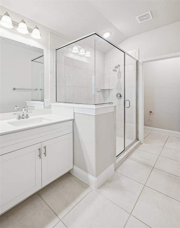 3073 Hamilton Street Plano, TX 75075 - Photo 19 of 30 a bathroom with a sink a mirror and a shower