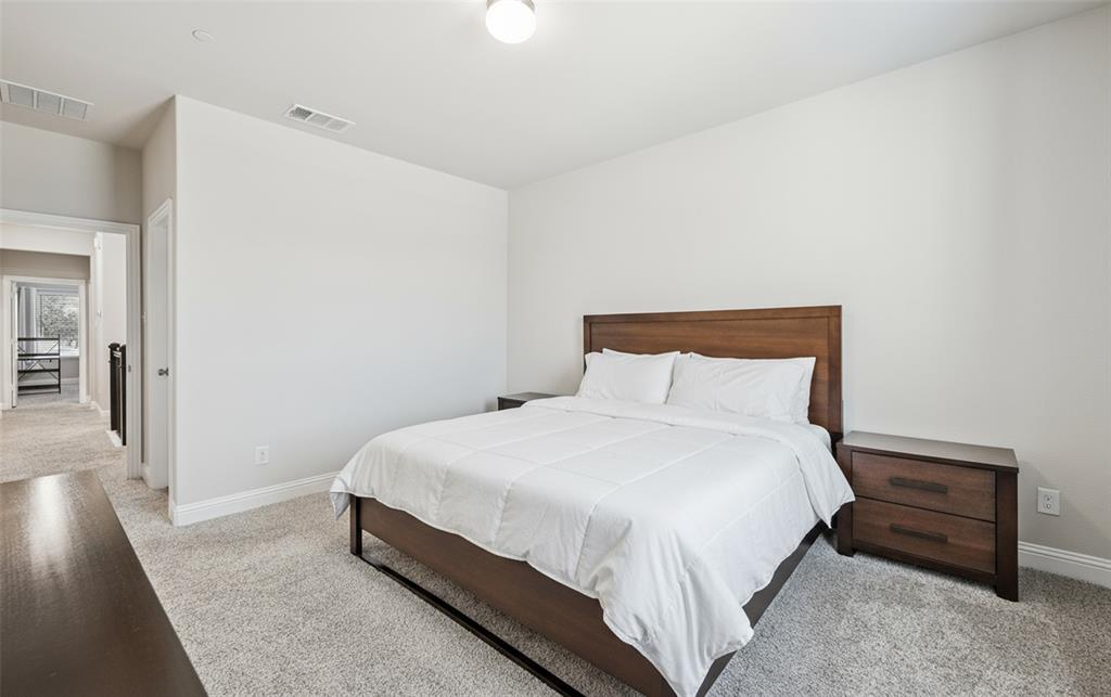 3073 Hamilton Street Plano, TX 75075 - Photo 22 of 30 a bedroom with a bed and wooden floor