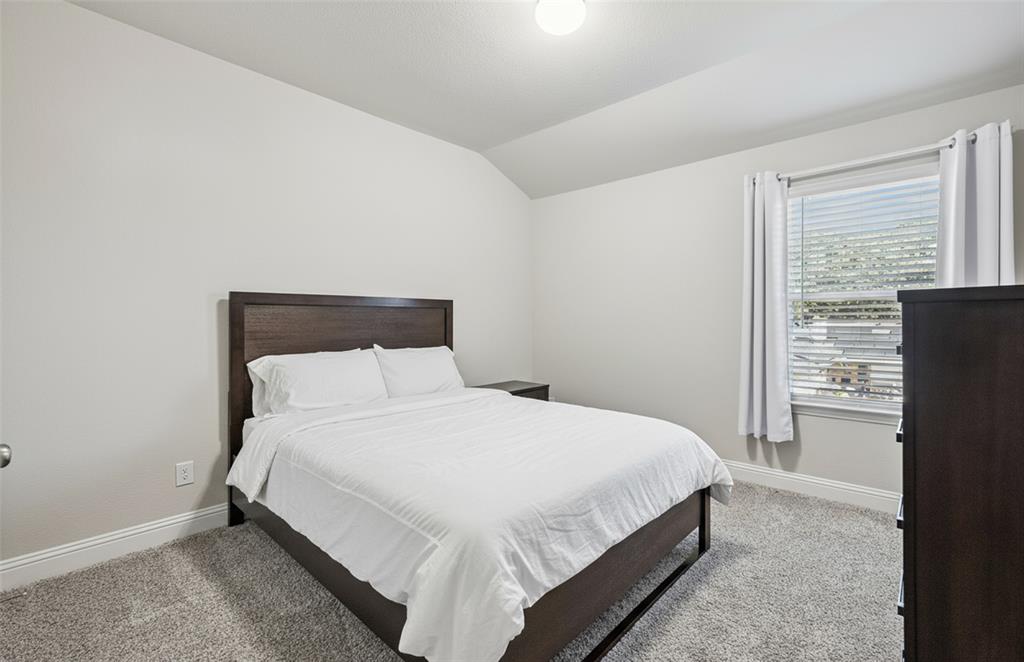 3073 Hamilton Street Plano, TX 75075 - Photo 23 of 30 a bedroom with a bed and a refrigerator