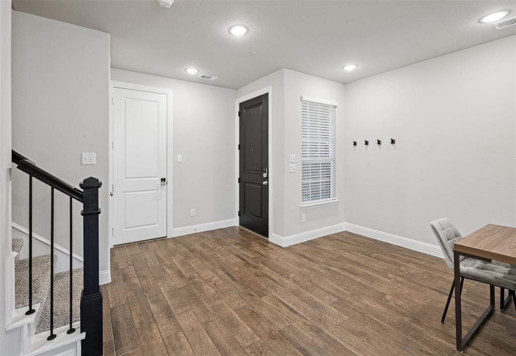 3073 Hamilton Street Plano, TX 75075 - Photo 5 of 30 a view of an empty room with wooden floor and a window