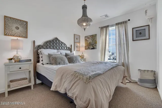 a spacious bedroom with a bed and window