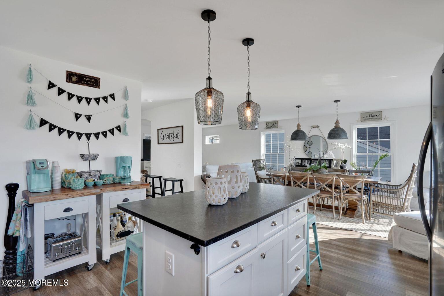 304 6th Avenue Seaside Heights, NJ 08751 - Photo 3 of 20 a view of a dining room and livingroom with furniture wooden floor a chandelier