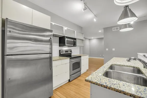 a kitchen with a sink cabinets and appliances