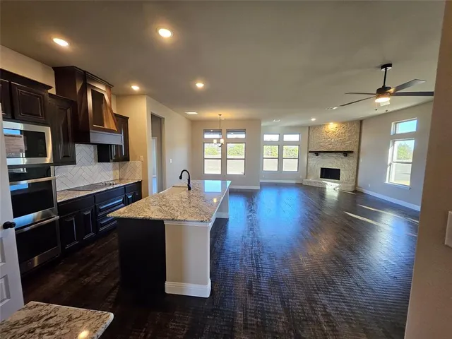 a living room with hardwood floor and a fireplace