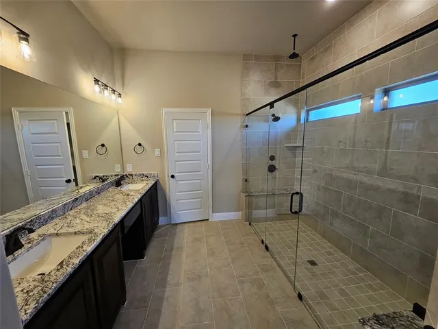 a bathroom with a shower and a glass door