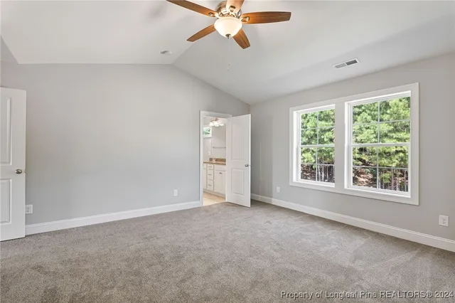 a bathroom with a granite countertop double vanity sink mirror and toilet