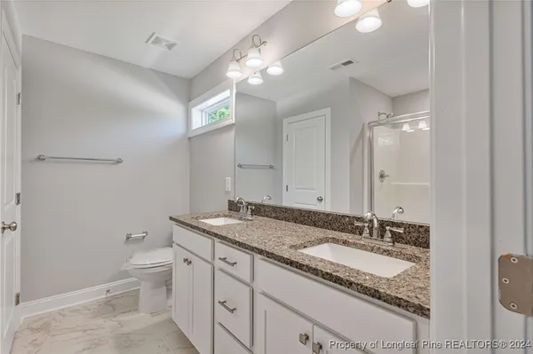 a bathroom with a glass shower door