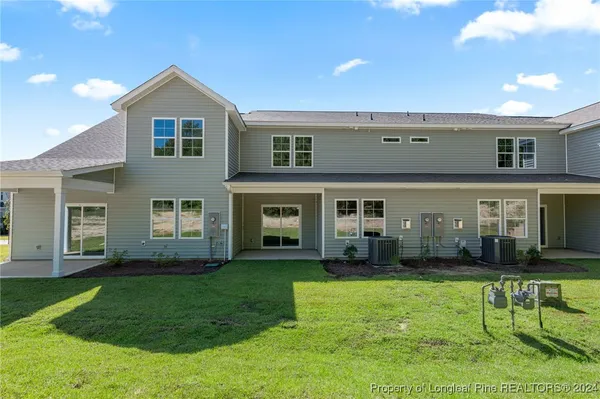 a front view of residential houses with yard