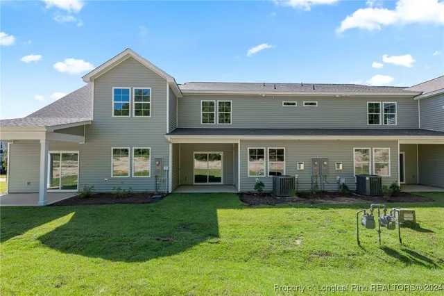 a front view of residential houses with yard