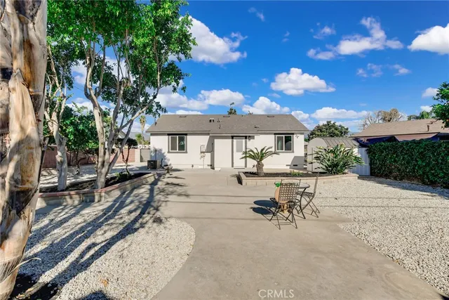 a view of a patio with a table and chairs under an umbrella