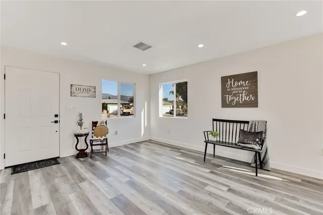 a view of room with wooden floor and furniture