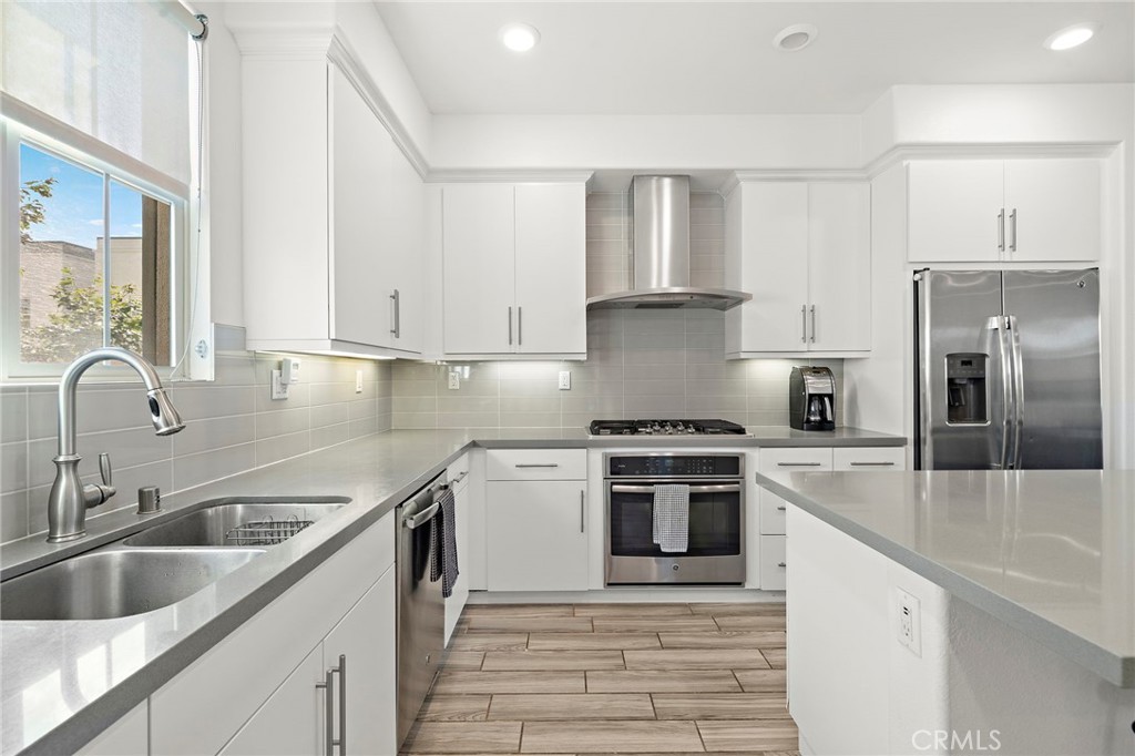 144 Paramount Irvine, CA 92618 - Photo 5 of 43 a kitchen with stainless steel appliances granite countertop a sink stove and refrigerator