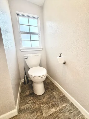 a white toilet sitting next to a window