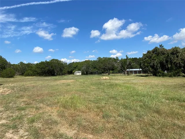 a view of outdoor space with green field and trees