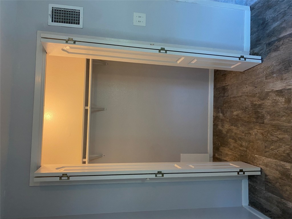19050 Farm To Market Road 150 West, Unit 1 Driftwood, TX 78619 - Photo 9 of 15 a view of an empty room with wooden floor and a window