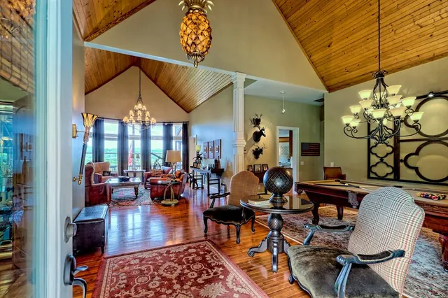 a living room with furniture a chandelier and a fireplace