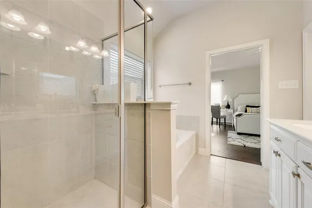 a bathroom with a glass shower door