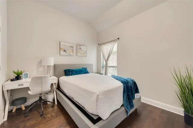 a bedroom with a bed and a table in it