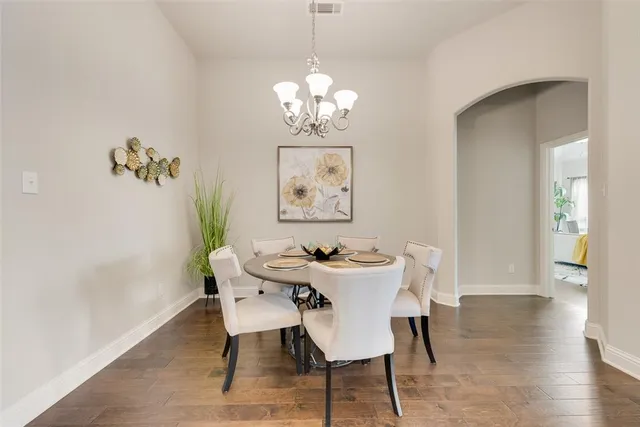 a view of a dining room with furniture wooden floor and a chandelier
