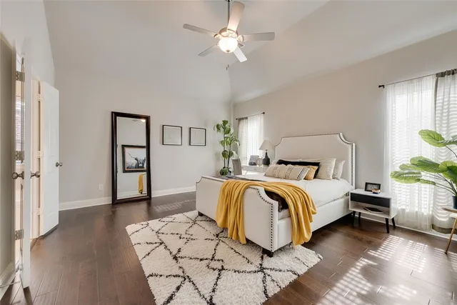 a bedroom with a bed and a chandelier