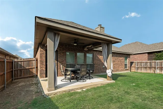 a view of a porch with a table and chairs