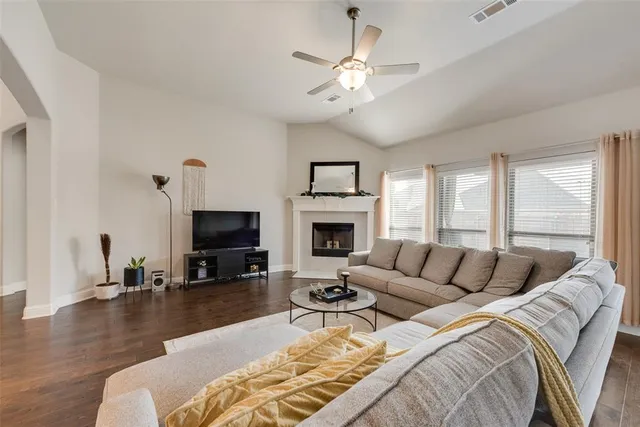 a living room with furniture fireplace and a large window