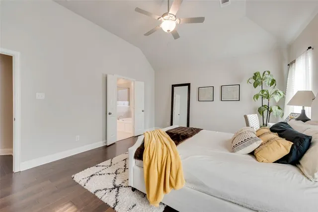 a bedroom with a bed and ceiling fan