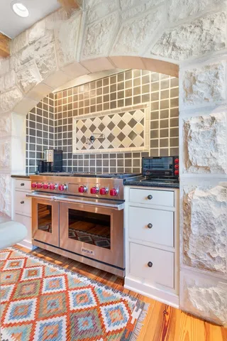 a spacious bedroom with a bed and a fireplace