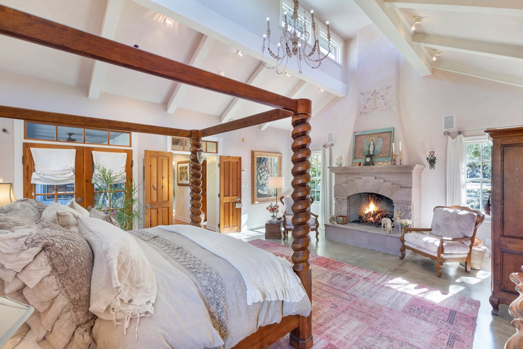 1129 Triple Creek Road Fredericksburg, TX 78624 - Photo 33 of 78 a spacious bedroom with a bed and a fireplace